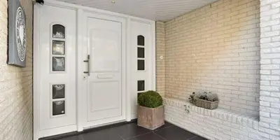 a front door of a house with a potted plant at Beach Studio in Zandvoort