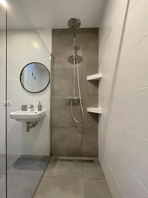 a bathroom with a shower and a sink and a mirror at Studio River, Luxe dichtbij strand en Duinen in Egmond aan Zee