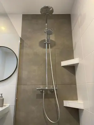 a shower with a shower head in a bathroom at Studio River, Luxe dichtbij strand en Duinen in Egmond aan Zee
