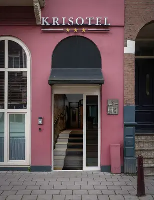a pink building with stairs in front of it at Krisotel in Amsterdam