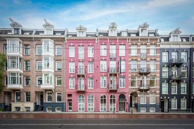 a pink building on the side of a street at Krisotel in Amsterdam
