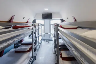 a room with several bunk beds in a dorm at Hostel Warmoes Amsterdam in Amsterdam