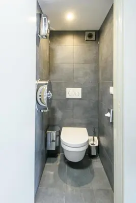 a bathroom with a toilet in a small room at Hostel Warmoes Amsterdam in Amsterdam