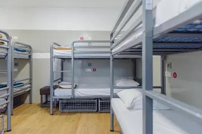 a bunk bed room with three bunk beds in it at Hostel Warmoes Amsterdam in Amsterdam