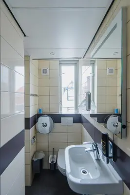a bathroom with a sink and a toilet at Hostel Warmoes Amsterdam in Amsterdam