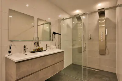 a bathroom with a sink and a shower at Wellness Suite Zeist in Zeist