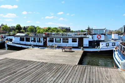 two boats docked at a dock with a picnic table at Amice in Haarlem