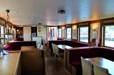 a dining car of a train with tables and chairs at Amice in Haarlem