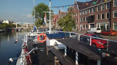 a boat is docked at a dock in the water at Amice in Haarlem