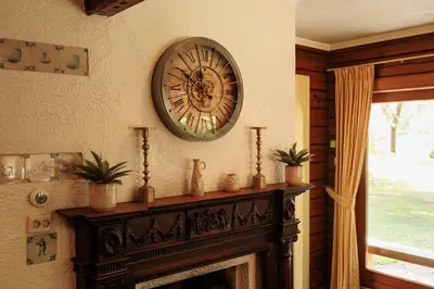 a clock on a wall above a fireplace at 't Eekhoornnest in Soest