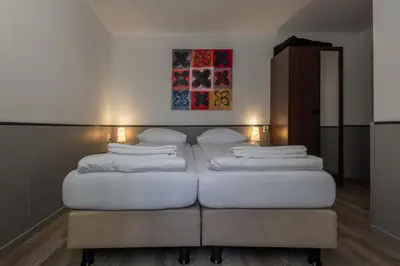 a bedroom with two beds in a room at Hotel Randenbroek in Amersfoort