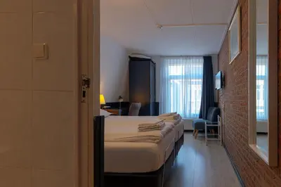 a row of beds in a hotel room at Hotel Randenbroek in Amersfoort