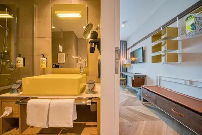 a bathroom with a sink and a mirror at Vienna House Easy by Wyndham Amsterdam Airport Schiphol in Hoofddorp