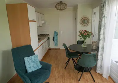 a kitchen and dining room with a table and chairs at Welcome by Bianca in Jisp