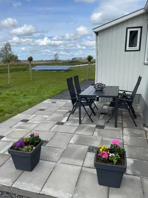 a patio with a table and chairs and flowers at Welcome by Bianca in Jisp