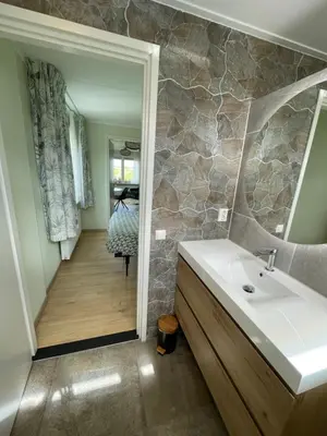 a bathroom with a sink and a stone wall at Welcome by Bianca in Jisp