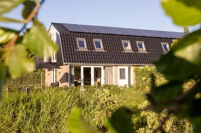 a house with solar panels on the roof at Ruyge Weyde Logies - The Farmers Daughter in Oudewater