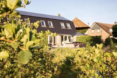 a house with solar panels on the roof at Ruyge Weyde Logies - The Farmers Daughter in Oudewater