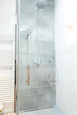 a bathroom with a shower with a glass door at Ruyge Weyde Logies - The Farmers Daughter in Oudewater