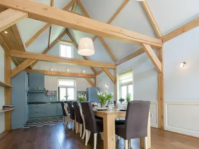 a dining room with a wooden table and chairs at Haven with Garden & Comfort in Zuidoostbeemster