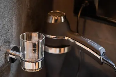 a glass sitting on a counter next to a coffee maker at Sotel Amsterdam Central Station in Amsterdam