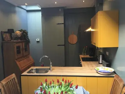 a kitchen with a sink and a counter top at B&B Alkmaars Toppunt XL in Alkmaar