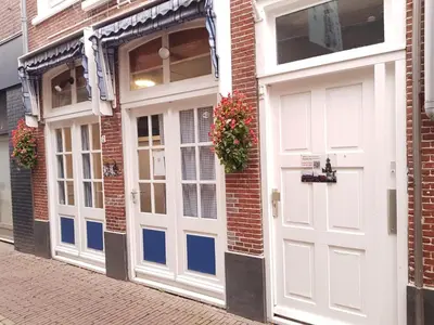 a pair of white doors on a brick building at B&B Alkmaars Toppunt XL in Alkmaar