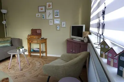 a living room with a couch and a tv at Rekerlanden 257 in Schoorldam