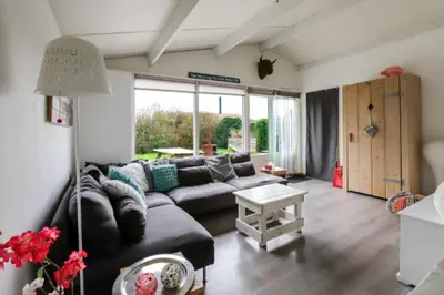 a living room with a couch and a table at Rekerlanden 195 in Schoorldam