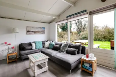 a living room with a couch and a table at Rekerlanden 195 in Schoorldam