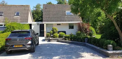 a car parked in front of a house at Lake House 74, luxury accommodation ir Sauna in Warmond
