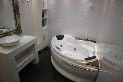 a white bathroom with a tub and a sink at Lake House 74, luxury accommodation ir Sauna in Warmond