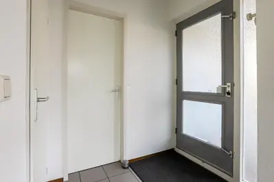 an empty room with two doors and a window at Zilt vakantiehuisje - Rekerlanden 283 in Schoorldam
