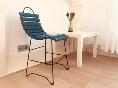 a blue chair sitting next to a white table at Little Tulip in Amsterdam