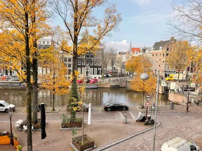 a view of a city with a river and buildings at Little Tulip in Amsterdam