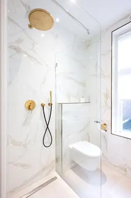 a white bathroom with a shower and a toilet at Anegang Boutique Hotel in Haarlem