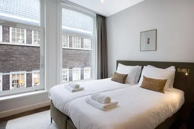 a bedroom with a large bed with towels on it at Anegang Boutique Hotel in Haarlem
