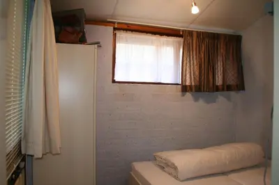 a small bathroom with a window and a mattress at Rekerlanden 173 in Schoorldam