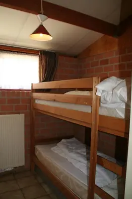 two bunk beds in a room with a brick wall at Rekerlanden 173 in Schoorldam