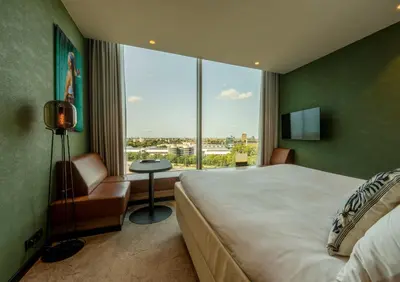 a bedroom with a large bed and a large window at Van der Valk Hotel Amsterdam Zuidas-Rai in Amsterdam
