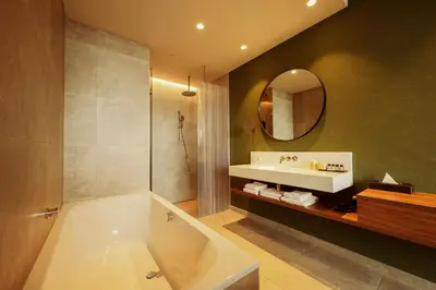 a bathroom with a tub and a sink and a mirror at Van der Valk Hotel Amsterdam Zuidas-Rai in Amsterdam