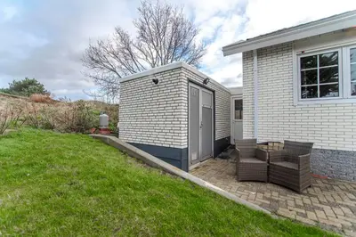 a small house with a door on the side of it at Studio the Dunes in Zandvoort