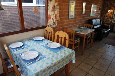 a dining room with a table and chairs and a table and chairsktop at Rekerlanden 161 in Schoorldam