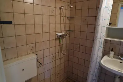 a bathroom with a shower and a sink at Rekerlanden 161 in Schoorldam