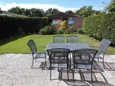 a table and four chairs sitting around a patio at Rekerlanden 161 in Schoorldam