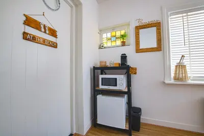 a microwave sitting on a shelf in a room at Sea Cottage Zandvoort in Zandvoort