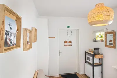 a room with a white door and a pendant light at Sea Cottage Zandvoort in Zandvoort