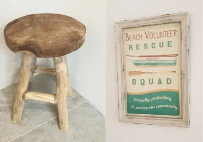 a wooden stool next to a picture of a sign at Sea Cottage Zandvoort in Zandvoort