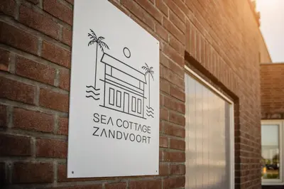 a sign on the side of a brick building at Sea Cottage Zandvoort in Zandvoort