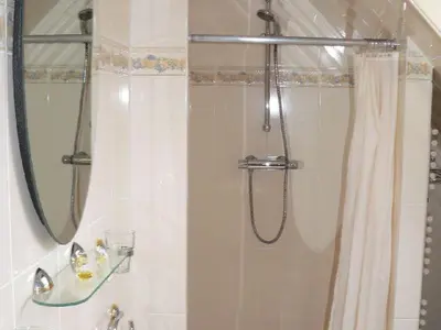 a bathroom with a shower with a shower curtain at Westenwind in Egmond aan Zee